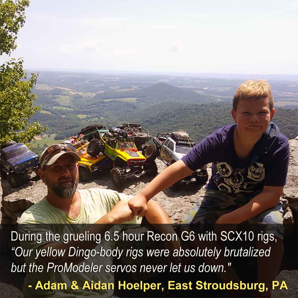 Close up of a father and son team resting at the summit after a grueling day competing in a toy model truck competition event.