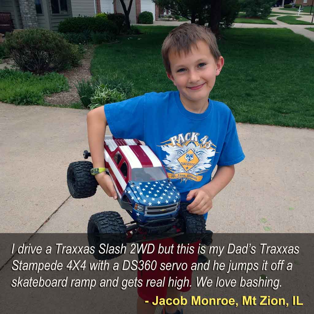 Proudly posing with his toy truck model, a young man is being mentored by his father on the mechanical skills that will serve a lifetime and which can't be learned playing with a Nintendo Switch.